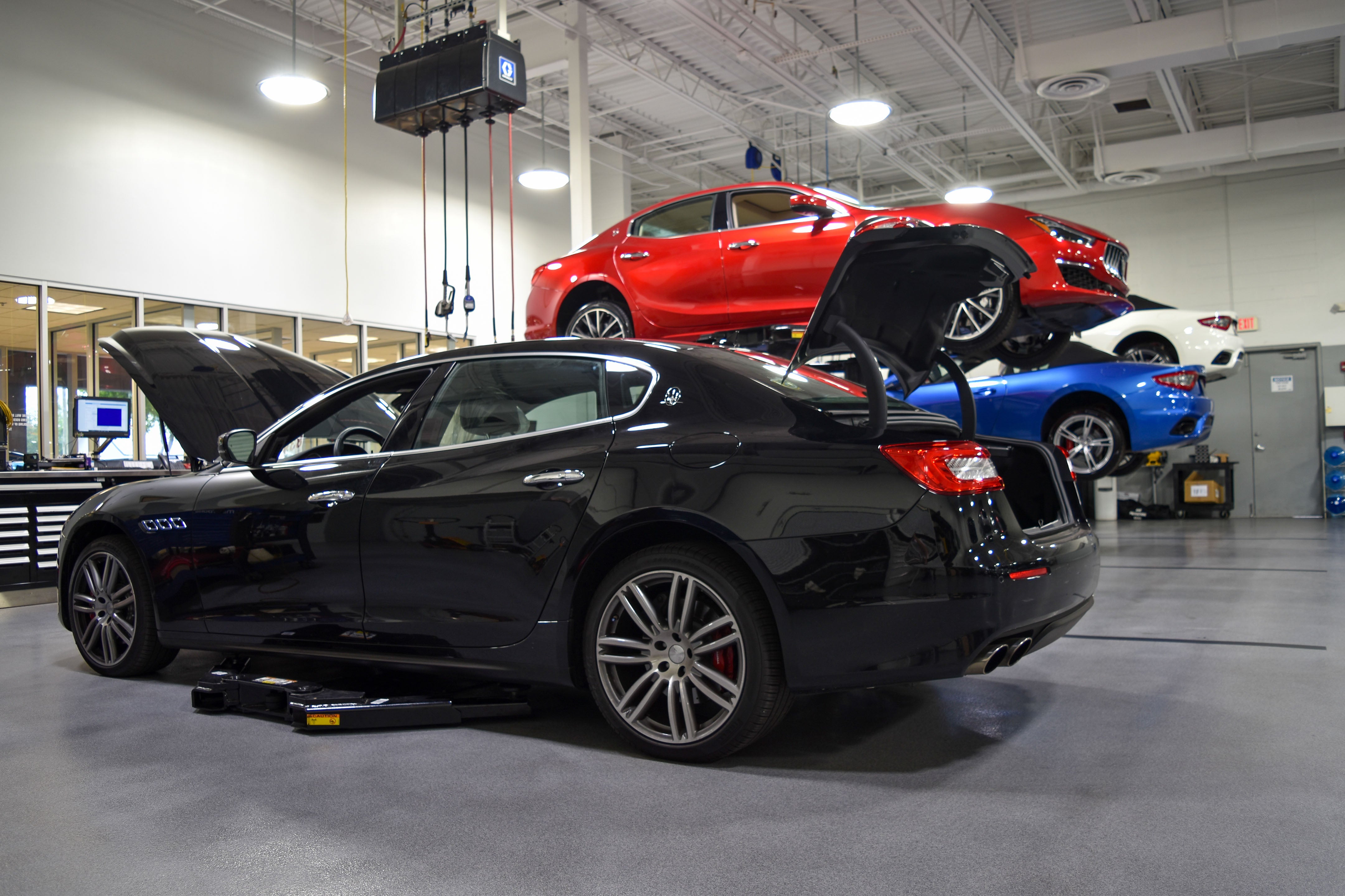 Luxury vehicles being serviced in Maserati Naples Service center