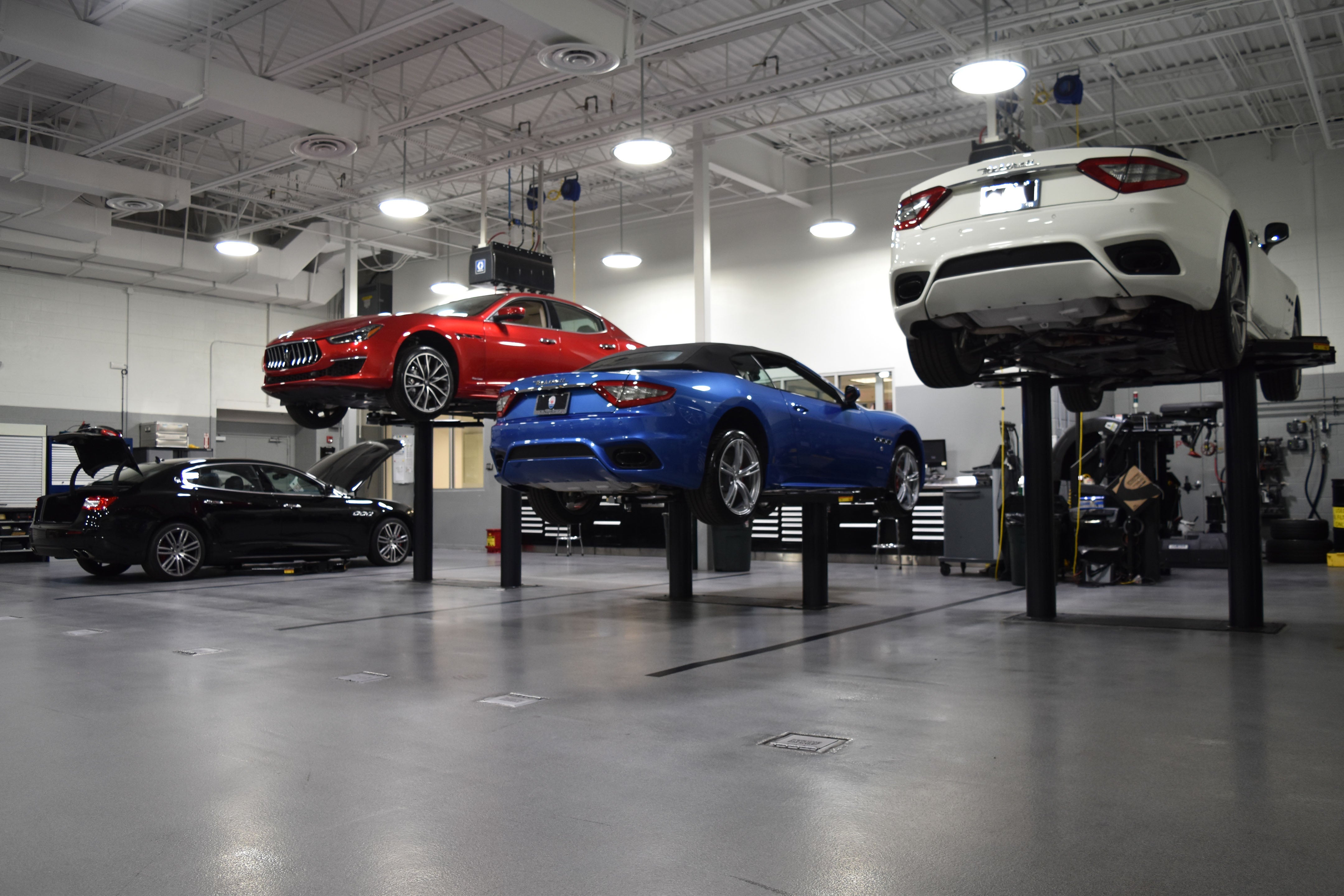 Luxury vehicles being serviced in Maserati Naples Service center