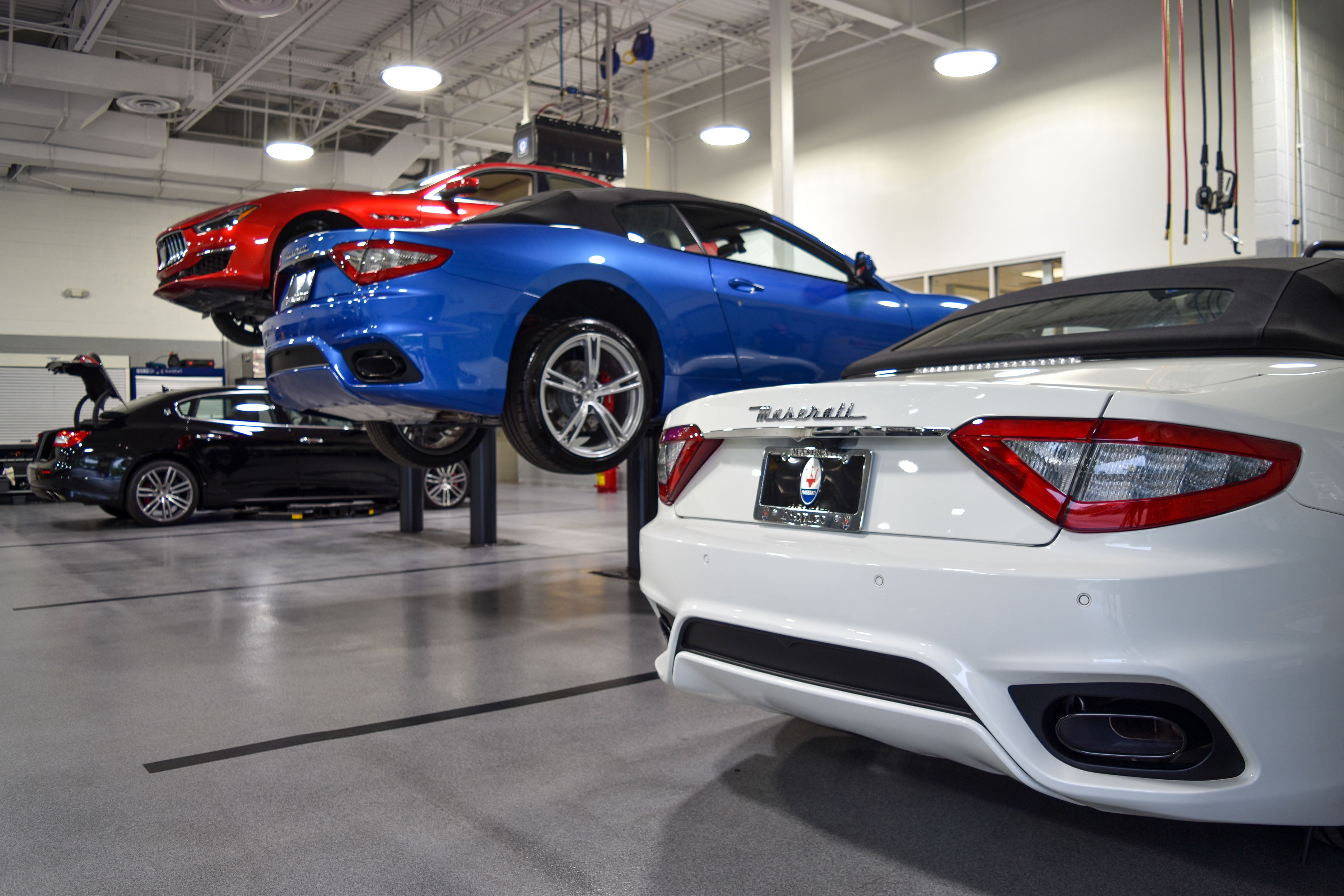 Luxury vehicles being serviced in Maserati Naples Service center